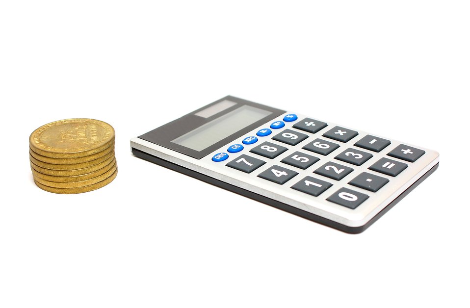 Free Stock Photos | A calculator and a stack of gold coins 