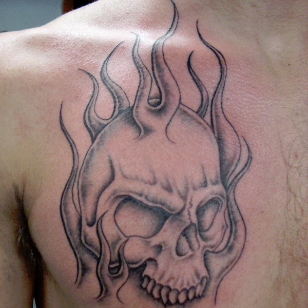 flaming skull tattoo chest.