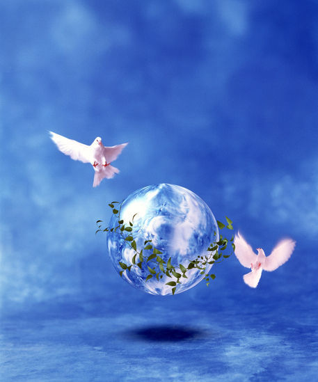 Two doves fly around clear globe hovering in blue space with 