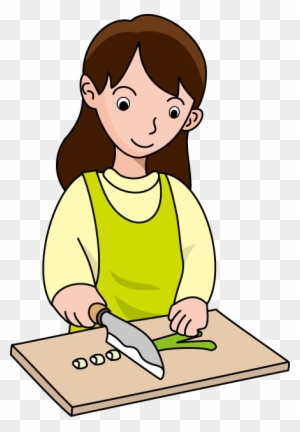 A smiling woman in a green apron chopping vegetables on a wooden cutting board with a knife.