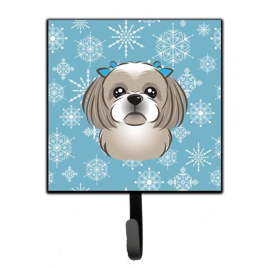 Shih Tzu dog with blue bows on a light blue snowflake background, mounted on a black wall hook.