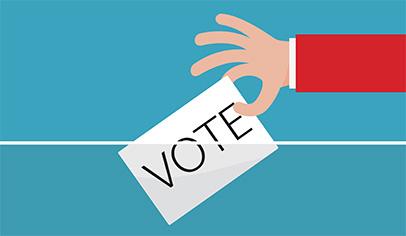 A hand in a red sleeve drops a white ballot labeled "VOTE" into a ballot box slot against a teal background.