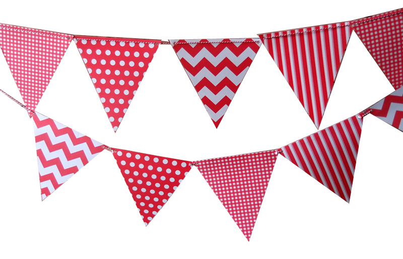Red and white bunting flags with polka dots, chevrons, stripes, and gingham patterns strung in two rows against a white background.