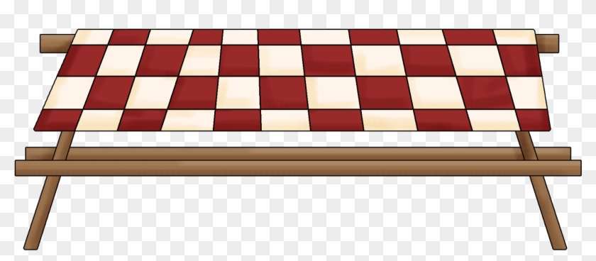 Red and cream checkerboard tablecloth draped over a wooden picnic-style frame.