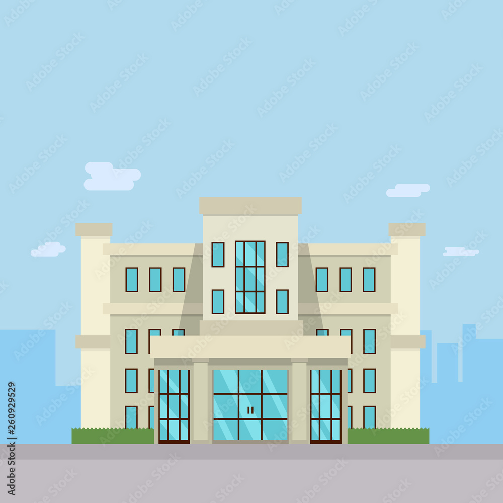 Modern beige office building with large glass windows and symmetrical design under a clear blue sky.