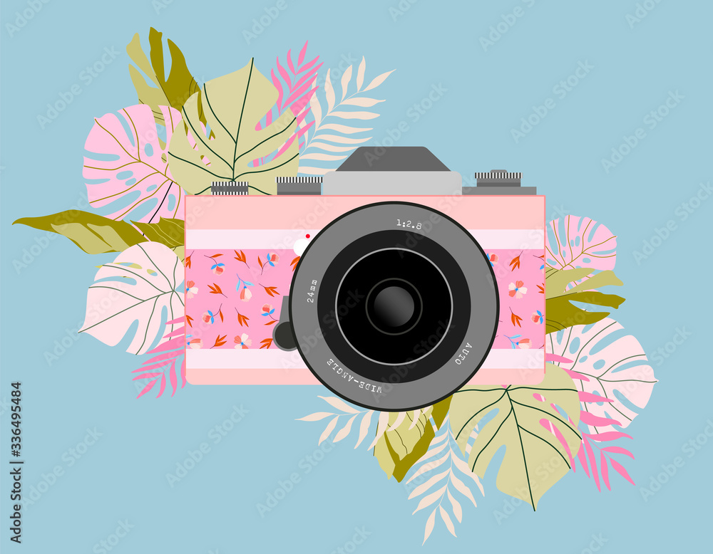 Pink floral-patterned vintage camera surrounded by tropical leaves on a light blue background.