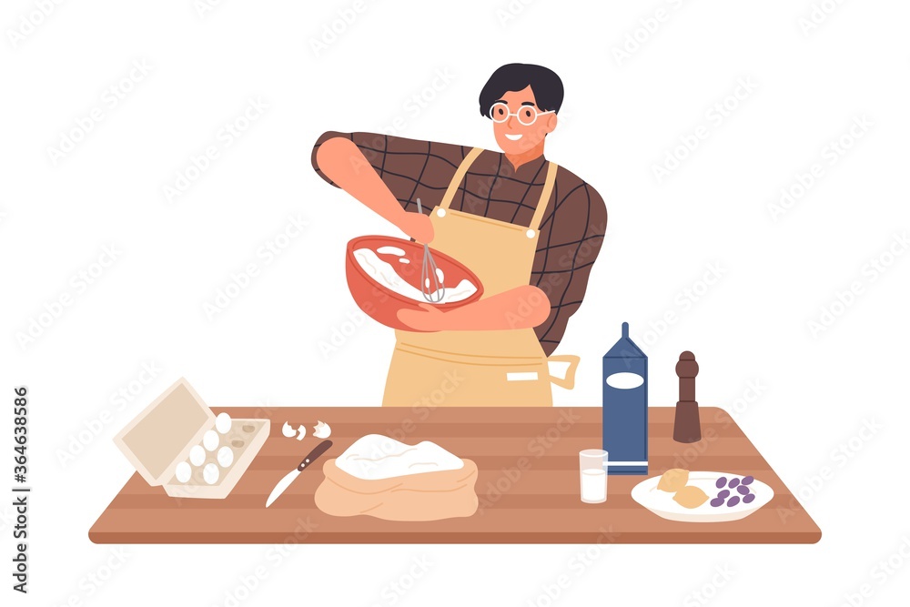 A smiling person in an apron whisking ingredients in a bowl, surrounded by baking supplies on a wooden table.