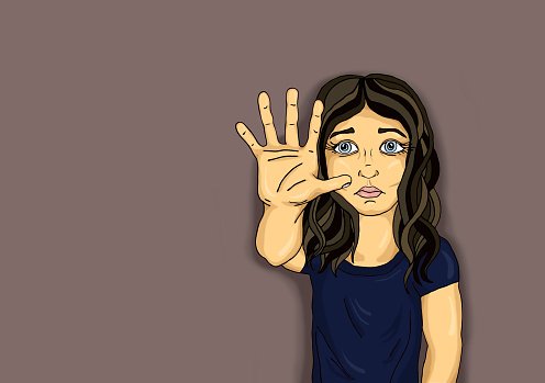 Young woman with long dark hair holds up open hand in a "stop" gesture, expression serious and concerned.