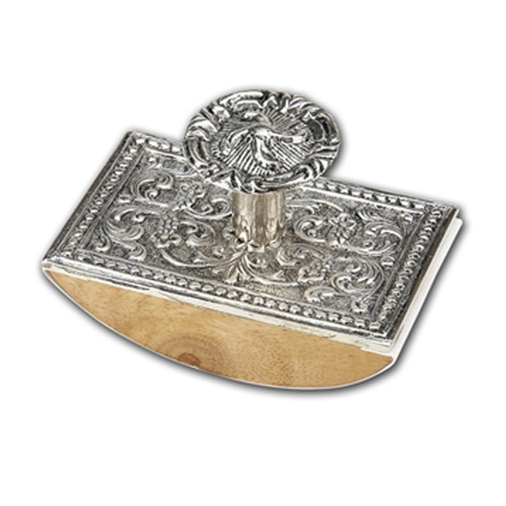 Ornate silver inkwell with intricate floral and foliate relief work, mounted on a curved wooden base with a decorative lid featuring a central motif.