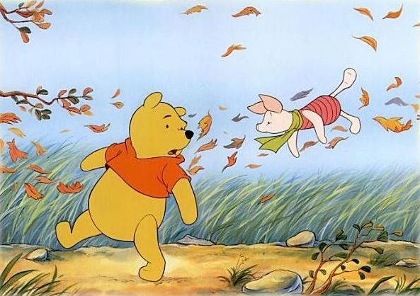Winnie the Pooh and Piglet joyfully chase autumn leaves in a breezy meadow.