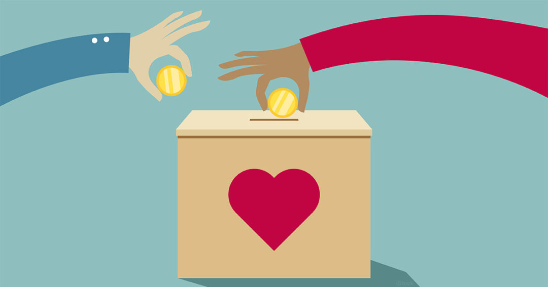 Two diverse hands placing gold coins into a donation box with a red heart symbol.