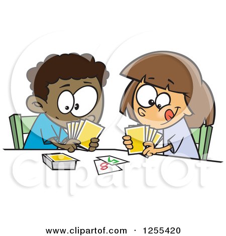 Two diverse children playing a card game at a table, smiling and focused.