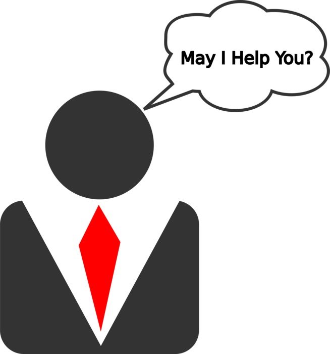 Businessperson in suit with red tie asking "May I Help You?" in speech bubble.