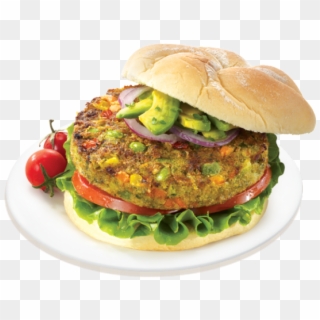 Veggie burger with avocado, red onion, tomato, and lettuce on a sesame bun, served on a white plate with cherry tomatoes.