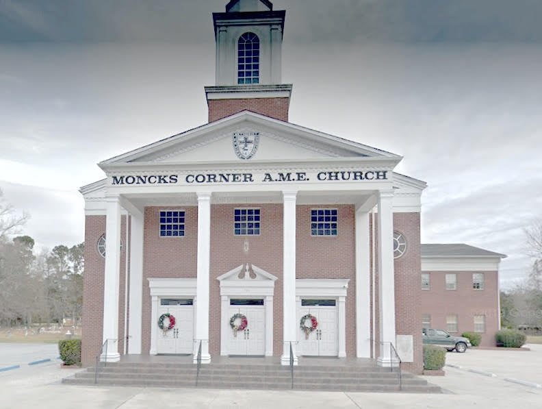 Moncks Corner A.M.E. Church, a brick building with white columns, steeple, and festive wreaths on the doors.