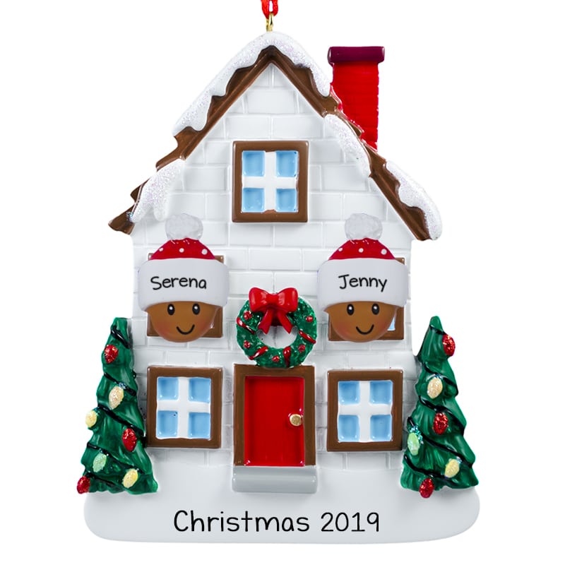 Personalized Christmas house ornament with two figures named Serena and Jenny, decorated trees, wreath, and "Christmas 2019" base.