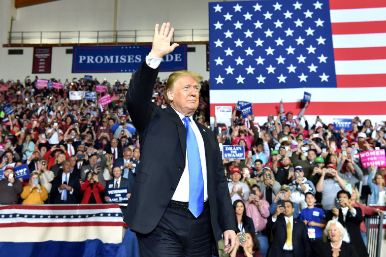 Trump Rally Photo: Crowded Event with American Flag and Campaign Signs