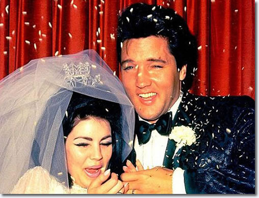 Elvis Presley and Priscilla Beaulieu on their wedding day, surrounded by confetti and red curtains.