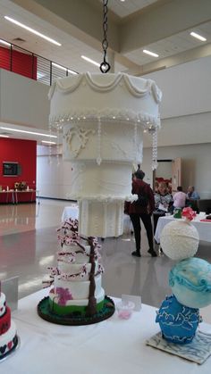 Elegant Suspended Wedding Cake Display at Catering Expo