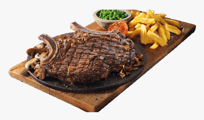 Grilled tomahawk steak with mushrooms, fries, peas, and roasted tomato on a wooden board.