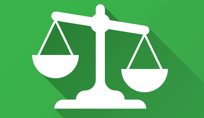 White justice scale icon on green background, symbolizing fairness and legal balance.