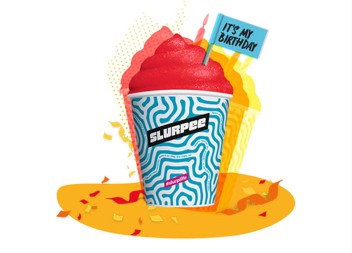 A colorful Slurpee cup with red slush, birthday flag, and confetti, celebrating a birthday.