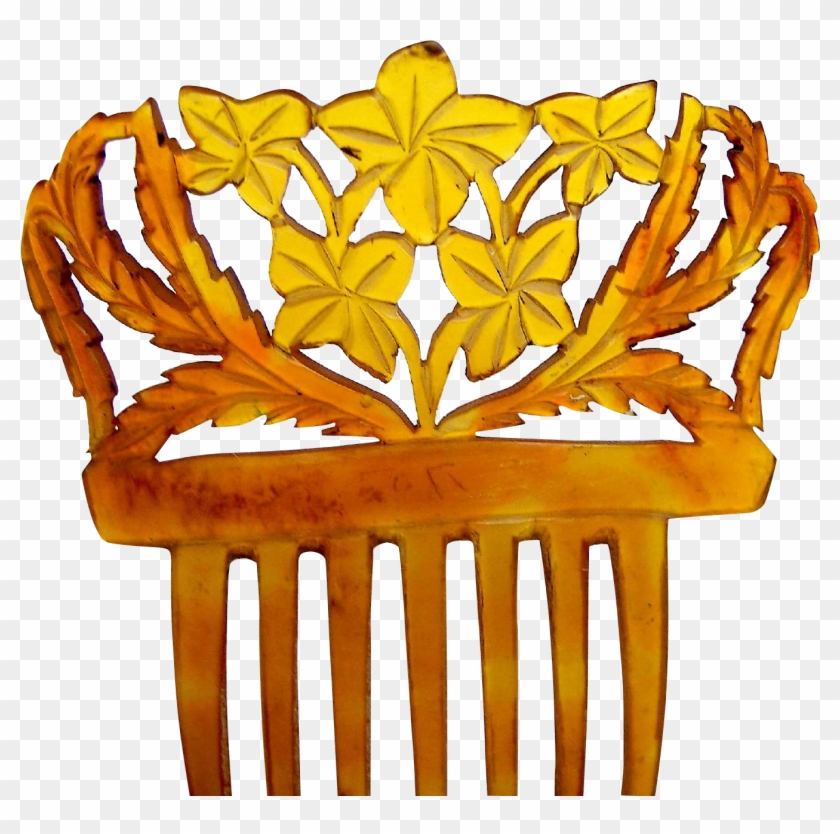 Intricately carved amber-colored hair comb with floral and leaf motifs, vintage decorative style.