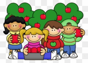 Four diverse children holding red apples in front of green apple trees, smiling and gathered around a laptop.