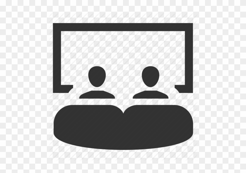 Two people watching a presentation on a large screen in a conference or classroom setting.