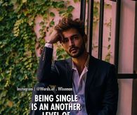 Man in dark suit posing thoughtfully against ivy-covered wall with inspirational quote overlay.