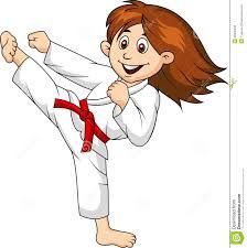 Young girl in white karate gi with red belt performing high kick, smiling confidently.