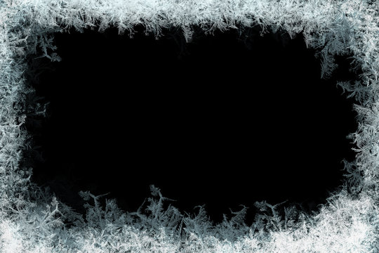 Frosty ice crystal border framing a black void, evoking winter chill and natural fractal patterns.