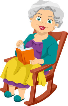 Elderly woman with gray hair smiling while reading a book in a wooden rocking chair, wearing colorful clothing.
