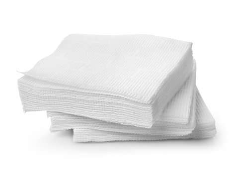 Stack of sterile white gauze pads on a clean white background, ready for medical or first-aid use.