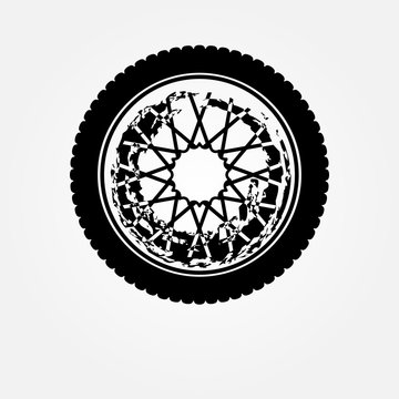 Stylized black-and-white wheel with intricate geometric hub pattern and scalloped tire edge.