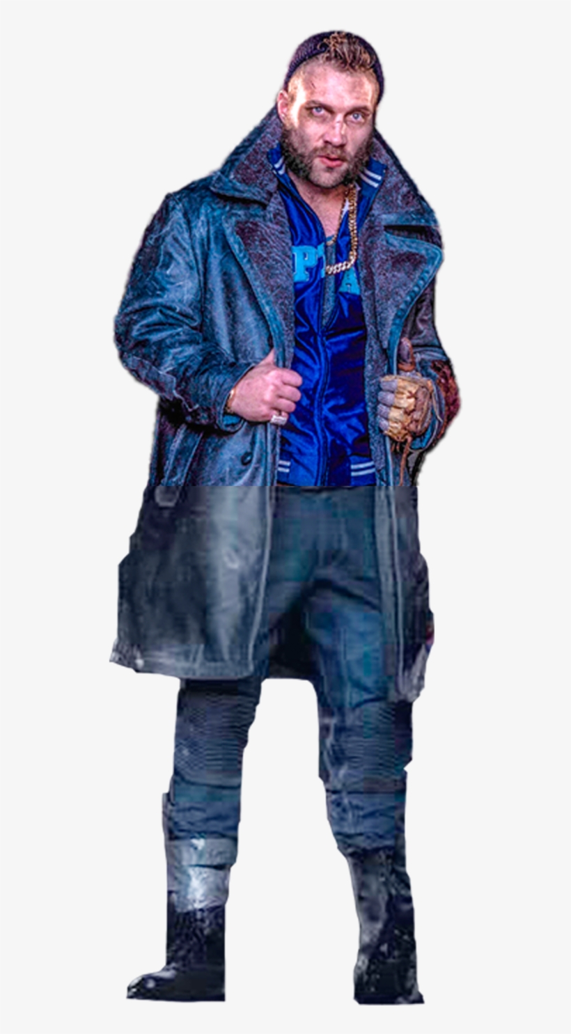 A rugged man in a weathered blue leather coat, blue satin shirt, and chain necklace poses confidently with one gloved hand raised.