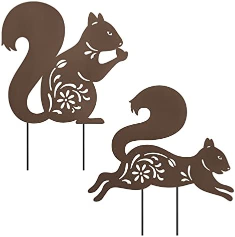 Two decorative metal squirrel garden stakes with floral cutout patterns, one sitting and one running.