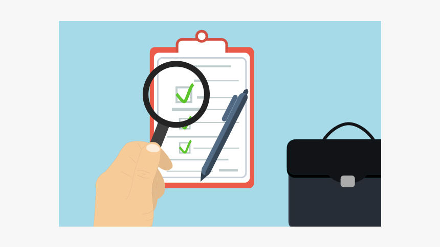 Hand holding magnifying glass over a checklist on a clipboard with green checkmarks and a pen beside it.