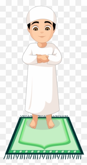 A young Muslim boy in white ihram clothing stands barefoot on a green prayer rug, hands folded in respectful posture.