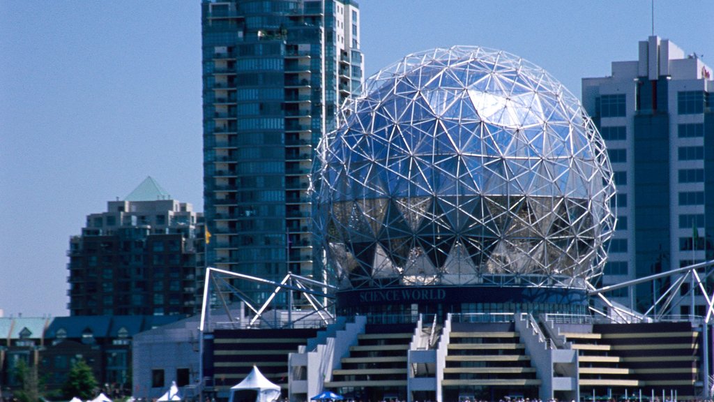 Science World’s geodesic dome in Vancouver, BC, with modern high-rises and clear blue sky in background.