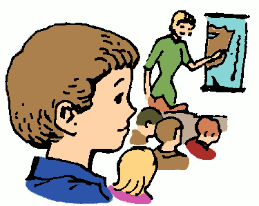 A teacher in green points to a map on the wall while students, including a boy in blue, watch attentively in a classroom setting.