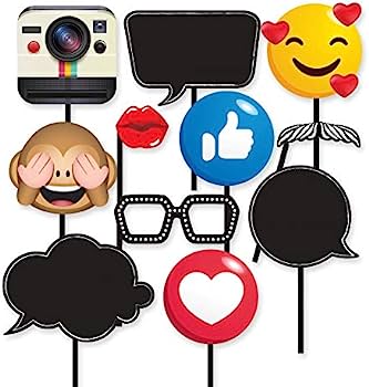 Assorted photo booth props including emoji faces, speech bubbles, glasses, lips, and a Polaroid camera on sticks.