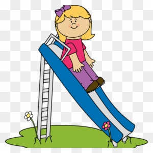 A smiling blonde girl in a pink shirt and purple pants slides down a blue playground slide with flowers nearby.