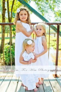 Charming Outdoor Portrait of Three Little Girls in White Dresses