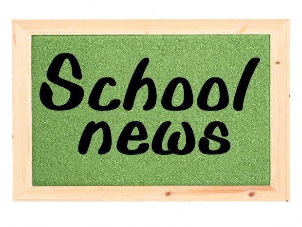 Green corkboard with wooden frame displaying "School news" in black handwritten-style text.