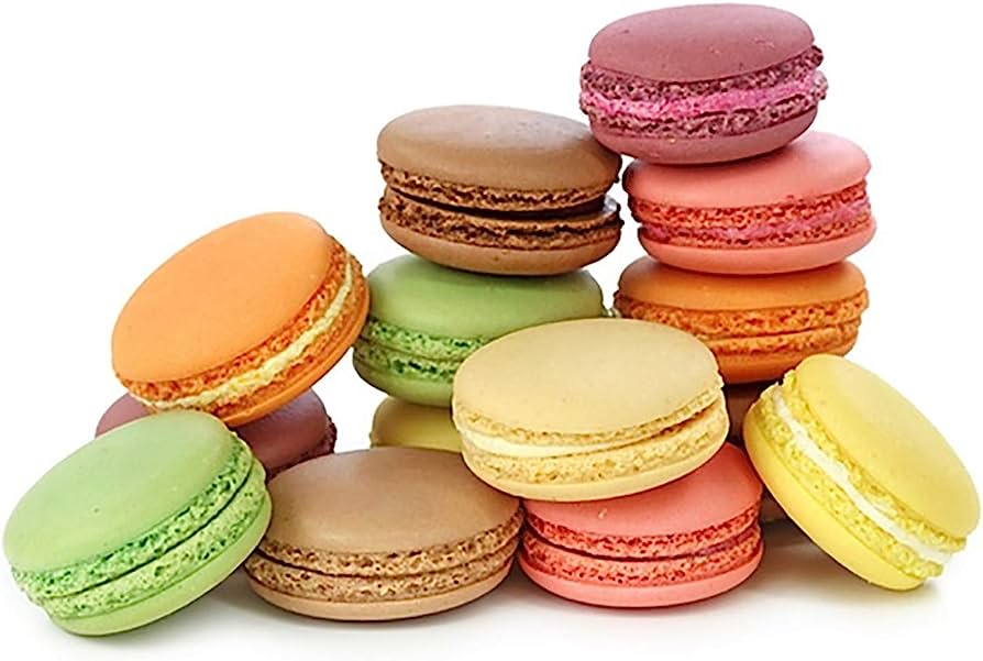 A colorful assortment of French macarons in pastel and vibrant hues, stacked and arranged on a white background.