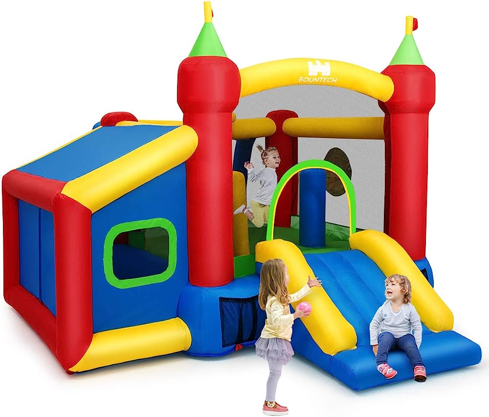Colorful Rountech inflatable bounce house with castle towers, slide, and three children playing joyfully.