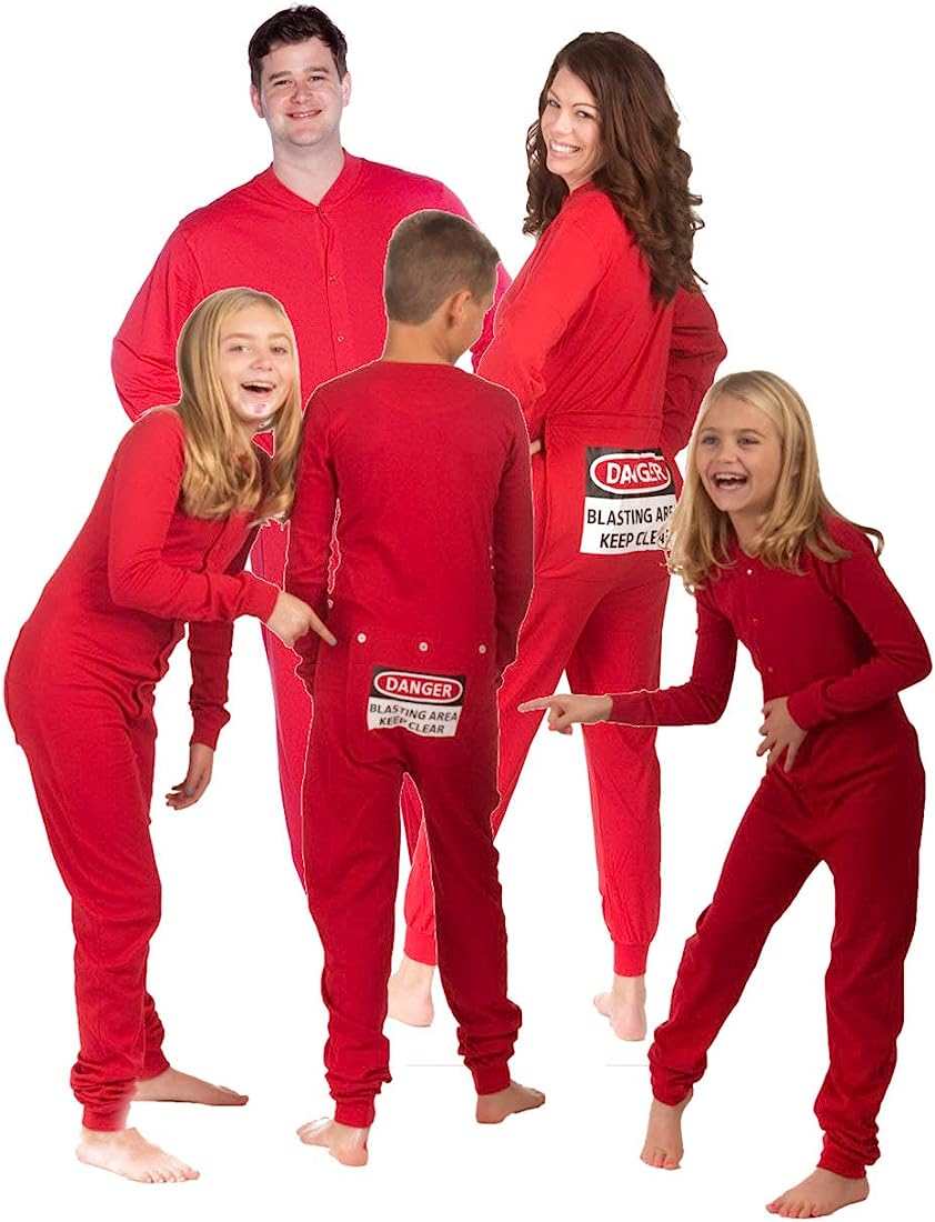 Family of five wearing matching red onesies with "DANGER: BLASTING AREA" warning labels on the back, posing playfully.