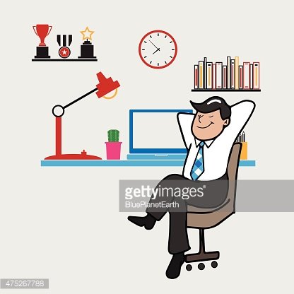 A smiling businessman relaxes in an office chair with hands behind head, surrounded by awards, books, a clock, and desk items.