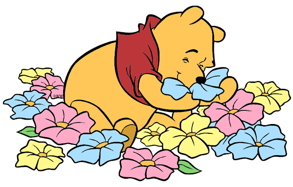 Winnie the Pooh lying among colorful flowers, holding a blue flower to his nose with eyes closed in delight.